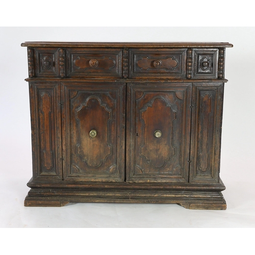 303 - A 17th century Tuscan walnut credenza, the rectangular moulded top, over a pair of shaped oval field... 