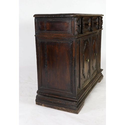 303 - A 17th century Tuscan walnut credenza, the rectangular moulded top, over a pair of shaped oval field... 