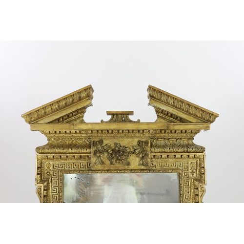 304 - A George II carved giltwood Adam design wall mirror, with broken arch pediment, raised flower and fr... 