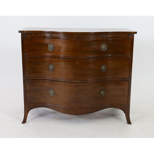 307 - A George III mahogany serpentine chest, with brushing slide and three graduated long drawers, on swe... 