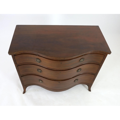 307 - A George III mahogany serpentine chest, with brushing slide and three graduated long drawers, on swe... 