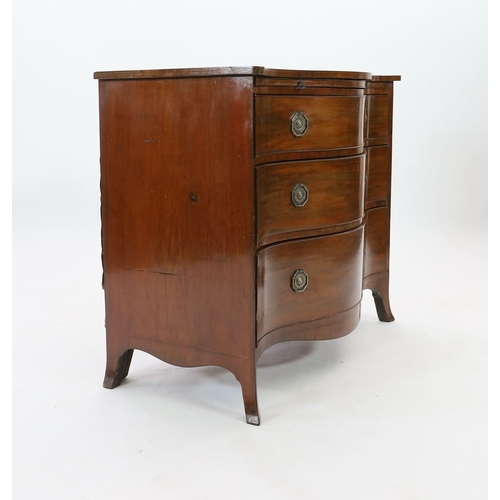 307 - A George III mahogany serpentine chest, with brushing slide and three graduated long drawers, on swe... 