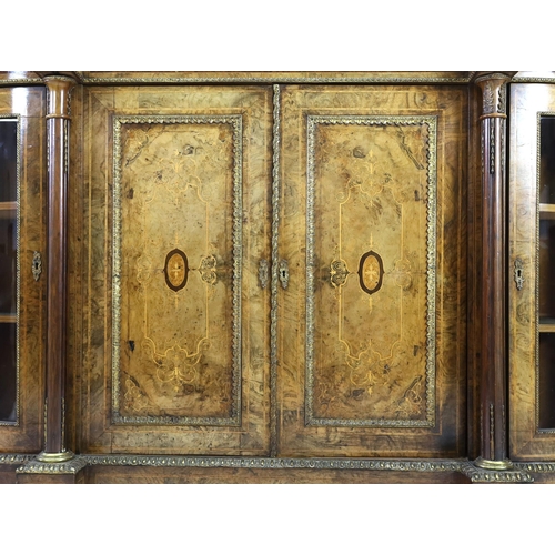 323 - A Victorian walnut and marquetry side cabinet, with central twin panelled doors and bowed glazed doo... 