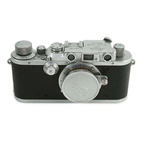 41 - A Leica IIIa camera, number 302196 with Leitz Elmar F51:35 lens, Elmar 5cm adapter ring and leather ... 