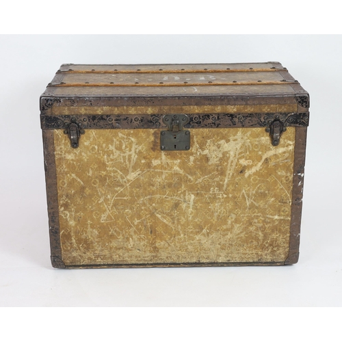 44 - An early 20th century Louis Vuitton iron bound travelling trunk, with yellow LV fabric covering and ... 