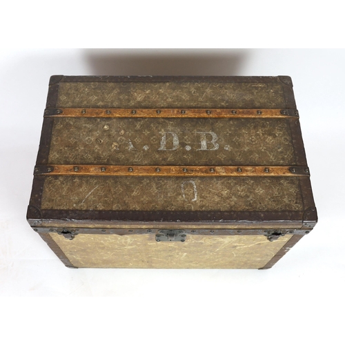 44 - An early 20th century Louis Vuitton iron bound travelling trunk, with yellow LV fabric covering and ... 