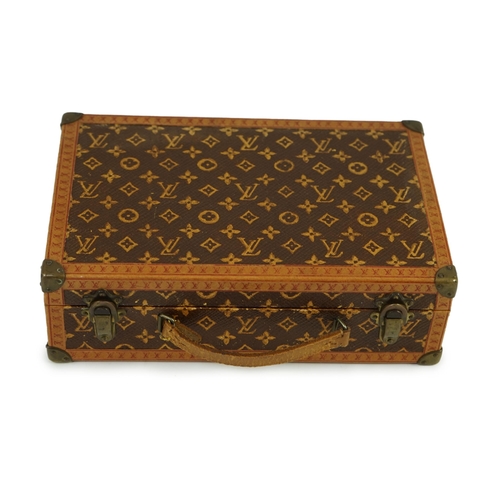 46 - A 1920s Louis Vuitton miniature suitcase, stamped L.Vuitton, 20 x 13 x 6cm.