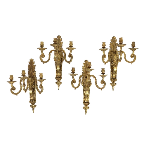 58 - A set of four early 20th century Louis XVI style ormolu three branch wall lights with acanthus, flow... 