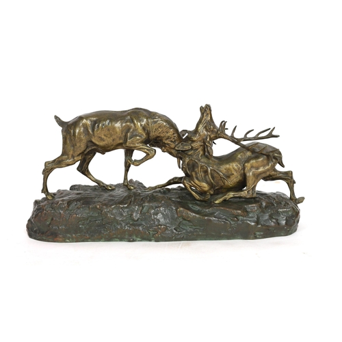 64 - Thomas-Francois Cartier (1879-1943). A bronzed group of rutting stags, standing upon a naturalistic ... 