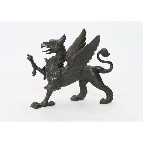 69 - A 19th century bronze model of a griffon, standing with raised paw, length 58cm, height 45cm