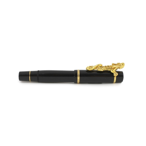 7 - A Mont Blanc Year of the Golden Dragon fountain pen, the cap applied with a dragon holding a pearl i... 