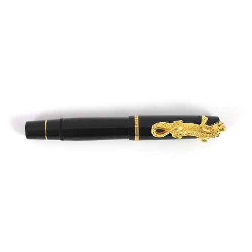 7 - A Mont Blanc Year of the Golden Dragon fountain pen, the cap applied with a dragon holding a pearl i... 