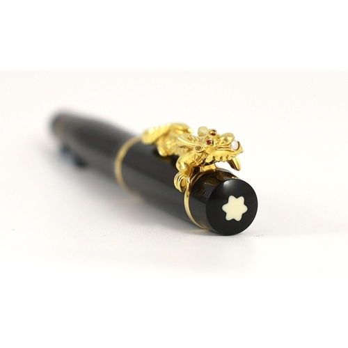 7 - A Mont Blanc Year of the Golden Dragon fountain pen, the cap applied with a dragon holding a pearl i... 