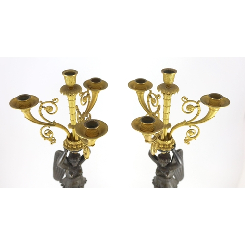 70 - A pair of 19th century French Empire style bronze and ormolu four light candelabra, each with female... 