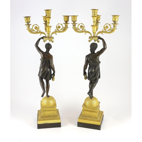 71 - A pair of 19th century French Empire style bronze and ormolu four light candelabra, each modelled wi... 