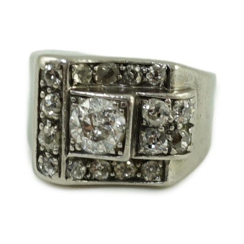 714 - An Art Deco platinum? and diamond cluster set dress ring, the central stone weighing approximately 0... 