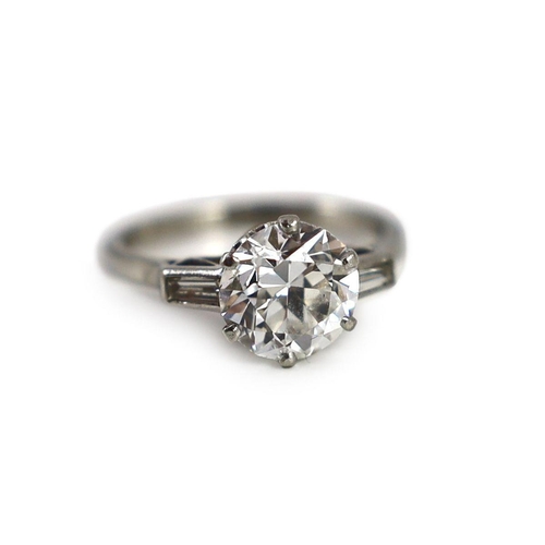 715 - A mid 20th century platinum and single stone diamond ring, with trapeze cut diamond set shoulders, t... 