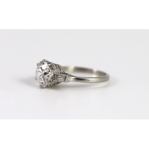 715 - A mid 20th century platinum and single stone diamond ring, with trapeze cut diamond set shoulders, t... 