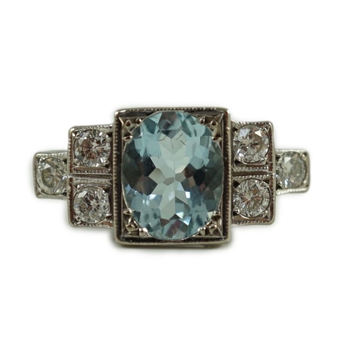 716 - An 18ct white gold oval cut aquamarine and six stone diamond cluster set dress ring, size O, gross 4... 