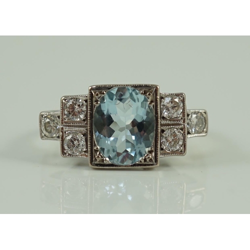 716 - An 18ct white gold oval cut aquamarine and six stone diamond cluster set dress ring, size O, gross 4... 