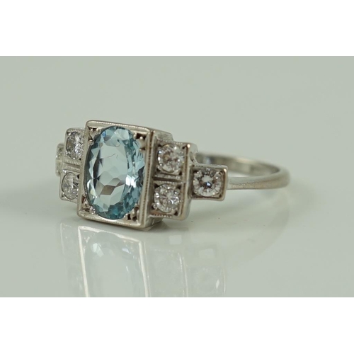 716 - An 18ct white gold oval cut aquamarine and six stone diamond cluster set dress ring, size O, gross 4... 