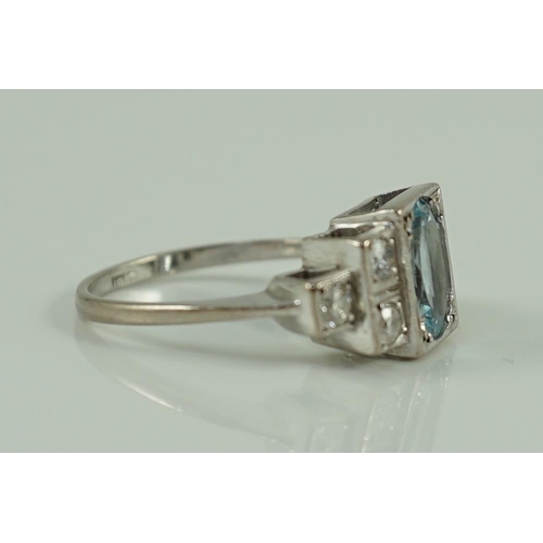 716 - An 18ct white gold oval cut aquamarine and six stone diamond cluster set dress ring, size O, gross 4... 