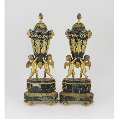 75 - A pair of Louis XVI style ormolu mounted green marble urns with fixed lids and cherub and eagle moun... 