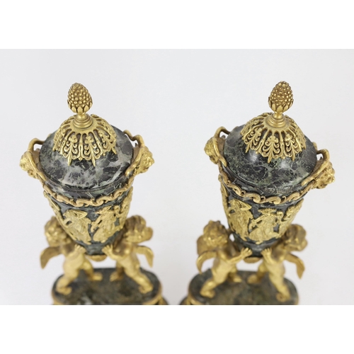 75 - A pair of Louis XVI style ormolu mounted green marble urns with fixed lids and cherub and eagle moun... 