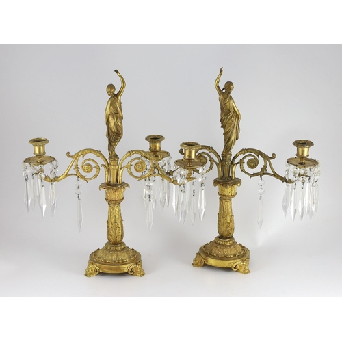 78 - A pair of 19th century Grecian revival ormolu two lights candelabra, with classical goddess finials,... 