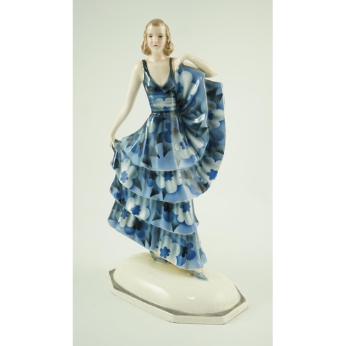 85 - A Goldscheider Art Deco pottery figure of a dancer, modelled by Dakon, wearing a blue floral dress, ... 