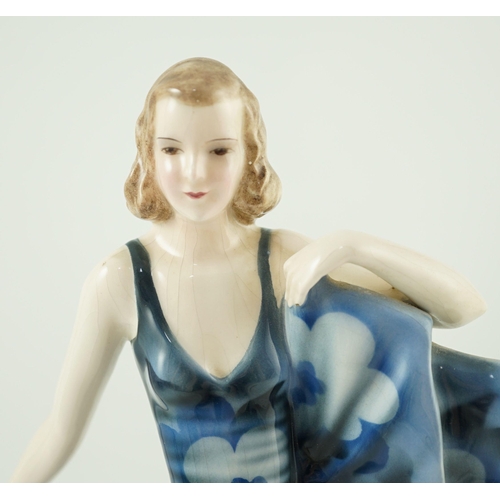 85 - A Goldscheider Art Deco pottery figure of a dancer, modelled by Dakon, wearing a blue floral dress, ... 