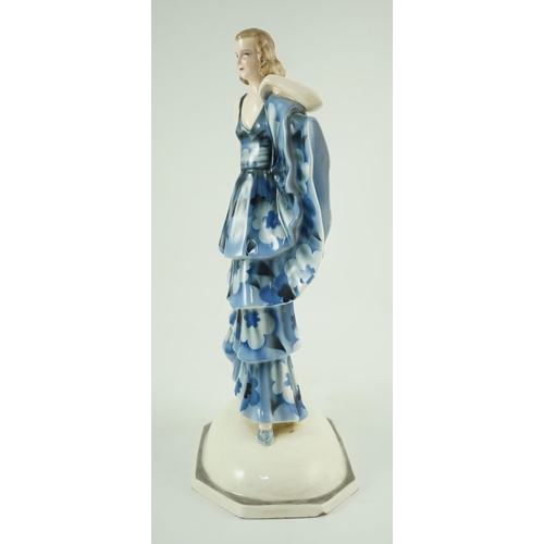 85 - A Goldscheider Art Deco pottery figure of a dancer, modelled by Dakon, wearing a blue floral dress, ... 