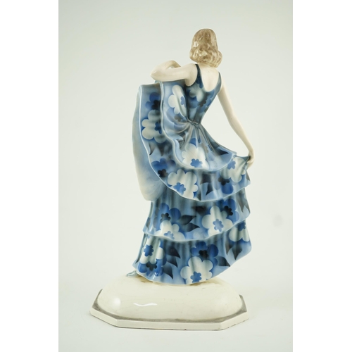 85 - A Goldscheider Art Deco pottery figure of a dancer, modelled by Dakon, wearing a blue floral dress, ... 