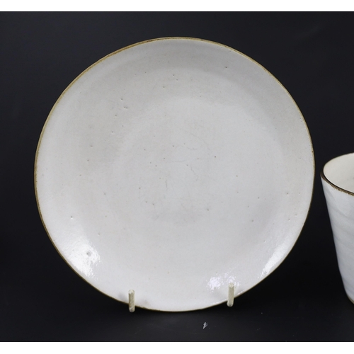 87 - Dame Lucie Rie (1902-1995) a cup, saucer and side plate, c.1959, each white glazed stoneware with ma... 