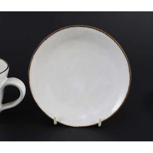 87 - Dame Lucie Rie (1902-1995) a cup, saucer and side plate, c.1959, each white glazed stoneware with ma... 