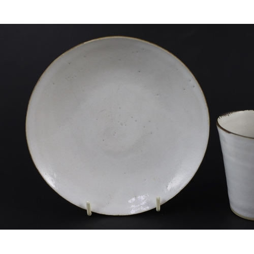 88 - Dame Lucie Rie (1902-1995) a cup, saucer and side plate, c.1959, each white glazed stoneware with ma... 