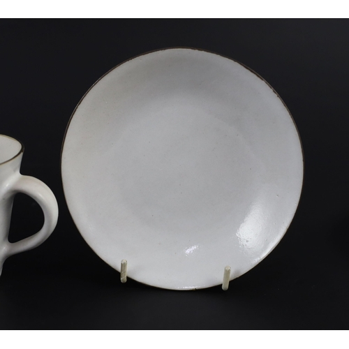 88 - Dame Lucie Rie (1902-1995) a cup, saucer and side plate, c.1959, each white glazed stoneware with ma... 