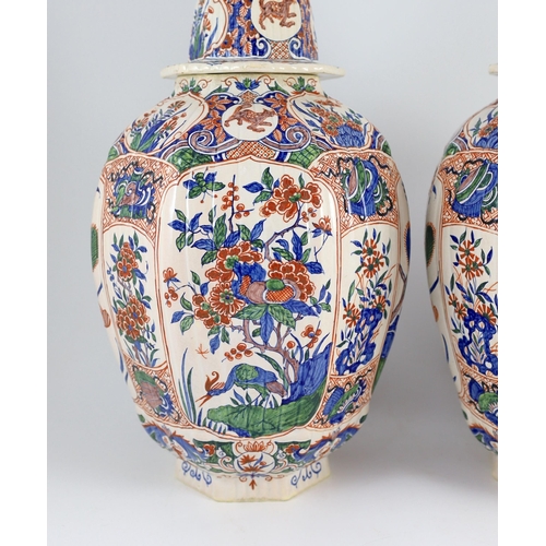 93 - A pair of large Delft jars and covers, Pieter Kocx factory De Grieksche A, c.1701-1722, each of lobe... 