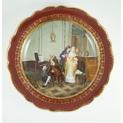 97 - A Meissen outside decorated dish, 19th century, painted with a courting couple in a music salon, wit... 