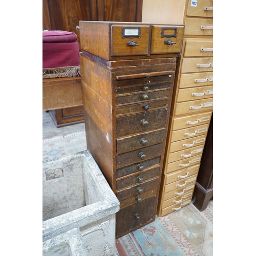 1052 - A vintage 11 drawer narrow chest containing assorted tools, height 108cm, together with an oak two d... 