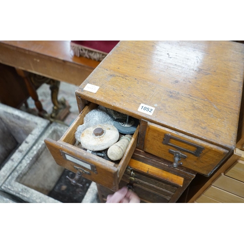 1052 - A vintage 11 drawer narrow chest containing assorted tools, height 108cm, together with an oak two d... 