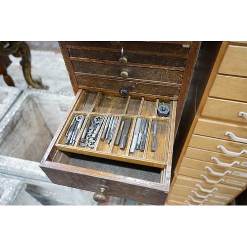 1052 - A vintage 11 drawer narrow chest containing assorted tools, height 108cm, together with an oak two d... 