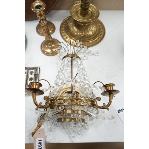 1497 - An embossed brass lamp, lustre drop wall light, a pair of bell-metal candlesticks, an 18th century p... 