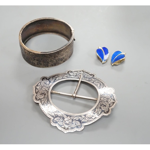 1915 - A late Victorian engraved silver hinged bangle, a white metal and niello buckle and a pair of mid 20... 