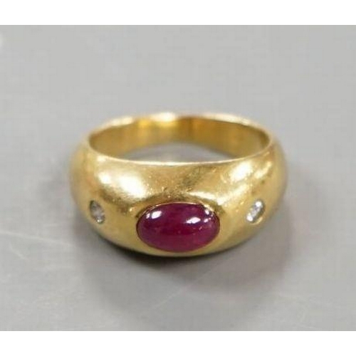 1923 - A yellow metal, cabochon ruby and two stone diamond chip set ring, size E/F, gross weight 6.6 grams.... 