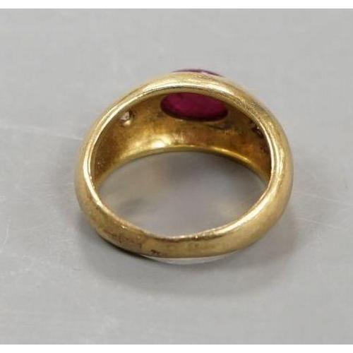 1923 - A yellow metal, cabochon ruby and two stone diamond chip set ring, size E/F, gross weight 6.6 grams.... 