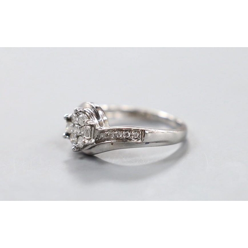 1924 - A modern 18kt white metal and diamond cluster set  ring, size P, gross weight 3.8 grams.