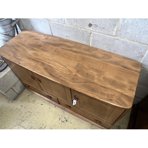 17 - An Ercol honeydew elm sideboard, width 129cm depth 49cm height 6cm