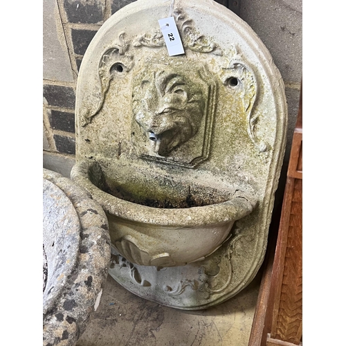 22 - A reconstituted stone garden wall mounted water fountain, with lion mask spout, width 48cm height 70... 