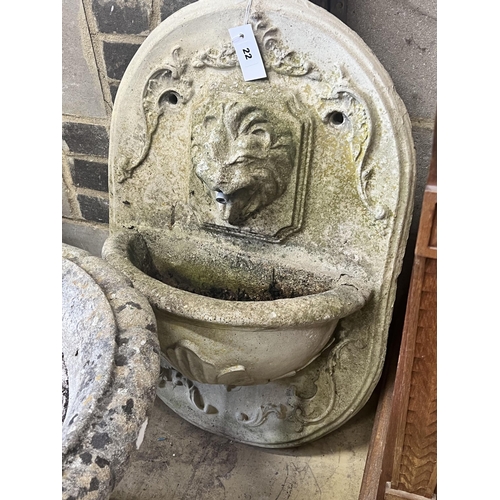 22 - A reconstituted stone garden wall mounted water fountain, with lion mask spout, width 48cm height 70... 